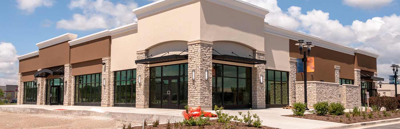 An image of an available one-level tan commercial building