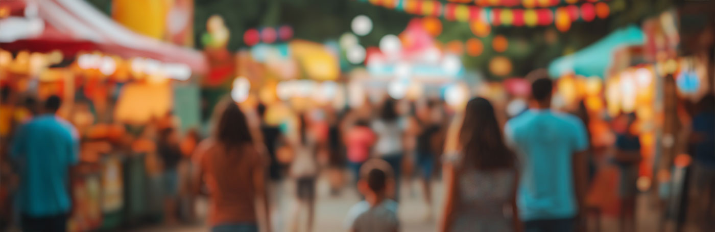 An out of focus view of people enjoying a street fair event